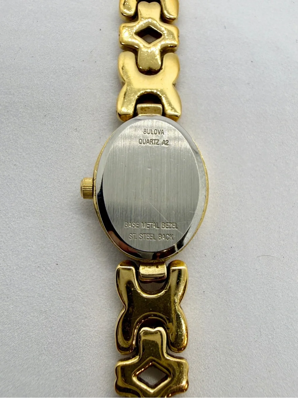 Bulova Gold Tone Dainty Oval Wristwatch Black Dial Textured Bezel Link Bracelet